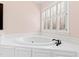 Bathroom featuring a large, white soaking tub with modern fixtures at 400 Tharps Ln, Raleigh, NC 27614