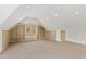 Spacious bonus room featuring built-in shelving and cabinets, neutral carpet, and unique window at 400 Tharps Ln, Raleigh, NC 27614