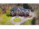 Aerial view of the home featuring brick, dark shutters, a circular driveway and immaculate landscaping at 400 Tharps Ln, Raleigh, NC 27614