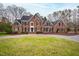 Beautiful brick home with a manicured lawn and circular driveway offering classic curb appeal at 400 Tharps Ln, Raleigh, NC 27614