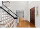 Bright foyer with hardwood floors, stairs, and entry door, creating a warm and inviting entrance at 400 Tharps Ln, Raleigh, NC 27614