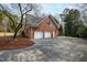 A detached red brick garage with a gray roof and a two-car driveway and plenty of space to park at 400 Tharps Ln, Raleigh, NC 27614