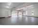 An empty garage with a gray floor and white walls with a view to the backyard at 400 Tharps Ln, Raleigh, NC 27614