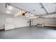 A large garage with white walls and shelving and a gray painted floor at 400 Tharps Ln, Raleigh, NC 27614