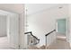 Upstairs hallway with chandelier and staircase at 400 Tharps Ln, Raleigh, NC 27614