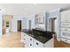 Spacious kitchen with island cooktop and white cabinetry with granite countertops at 400 Tharps Ln, Raleigh, NC 27614