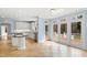 Light and airy kitchen featuring white cabinetry, cooktop island and access to the deck at 400 Tharps Ln, Raleigh, NC 27614