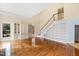 Open living space with hardwood floors, built-in shelving and staircase at 400 Tharps Ln, Raleigh, NC 27614