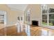 Spacious living room featuring a fireplace, hardwood flooring, and deck access at 400 Tharps Ln, Raleigh, NC 27614