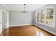 Elegant living room with hardwood floors, large window, and chandelier, providing natural light and style at 400 Tharps Ln, Raleigh, NC 27614
