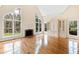 Bright living room with large arched windows, hardwood floors, and fireplace at 400 Tharps Ln, Raleigh, NC 27614