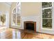 Comfortable living room featuring a fireplace, natural light and deck access at 400 Tharps Ln, Raleigh, NC 27614