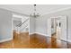 Open-concept living room featuring hardwood floors and a chandelier, perfect for entertaining and relaxing at 400 Tharps Ln, Raleigh, NC 27614
