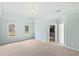 Spacious main bedroom with tray ceilings, large windows, and en-suite bathroom access at 400 Tharps Ln, Raleigh, NC 27614