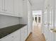 Pantry featuring granite countertops and white cabinetry at 400 Tharps Ln, Raleigh, NC 27614