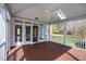 Covered back patio with stained wood floors, skylight and white railings at 400 Tharps Ln, Raleigh, NC 27614