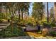 Multi-tiered backyard retreat with landscaping, a wooden deck, and mature trees at 402 Westwood Dr, Chapel Hill, NC 27516