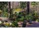 Landscaped backyard featuring a gazebo, a wooden deck, and a serene pond area at 402 Westwood Dr, Chapel Hill, NC 27516