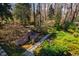 Expansive backyard featuring landscaped garden, deck, and pathways at 402 Westwood Dr, Chapel Hill, NC 27516