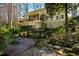 Multi-tiered backyard featuring a deck, patio and rock waterfall at 402 Westwood Dr, Chapel Hill, NC 27516