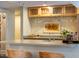 Well-appointed bar area with overhead glass rack, countertop space, and modern finishes at 402 Westwood Dr, Chapel Hill, NC 27516