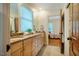 Bright bathroom with dual sinks and a view of the bedroom at 402 Westwood Dr, Chapel Hill, NC 27516