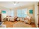 Cozy bedroom featuring hardwood floors, a comfortable bed, and a cozy chair at 402 Westwood Dr, Chapel Hill, NC 27516