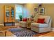 Cozy seating area with a small table and cabinet in a naturally lit room at 402 Westwood Dr, Chapel Hill, NC 27516