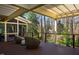 Beautiful deck with outdoor seating and screened-in porch overlooking lush green backyard at 402 Westwood Dr, Chapel Hill, NC 27516