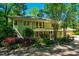 Charming two-story home with landscaped yard, beautiful trees, and a stone pathway at 402 Westwood Dr, Chapel Hill, NC 27516