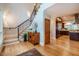 Warm foyer with hardwood floors, black iron staircase, and classic wooden accents at 402 Westwood Dr, Chapel Hill, NC 27516