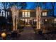 Charming home with a well-lit walkway, trees wrapped in lights, and attractive stone accents at 402 Westwood Dr, Chapel Hill, NC 27516