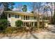 Charming front exterior featuring a well-maintained lawn, stone accents, and a two-car garage at 402 Westwood Dr, Chapel Hill, NC 27516