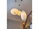 Striking overhead lighting fixtures illuminate a staircase and upper hallway at 402 Westwood Dr, Chapel Hill, NC 27516