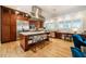 Spacious kitchen with stainless appliances, central island, and light wood floors at 402 Westwood Dr, Chapel Hill, NC 27516