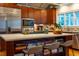 Kitchen island with seating, cooktop, stainless microwave, and stainless refrigerator at 402 Westwood Dr, Chapel Hill, NC 27516