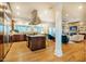Open kitchen with stainless steel appliances, stone counters, and an island cooktop at 402 Westwood Dr, Chapel Hill, NC 27516