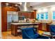 Bright kitchen features stainless steel appliances, island with seating, and custom cabinetry at 402 Westwood Dr, Chapel Hill, NC 27516