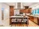 Bright kitchen features stainless steel appliances, island with seating, and custom cabinetry at 402 Westwood Dr, Chapel Hill, NC 27516