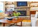 Living room featuring a stone fireplace, built-in shelving, cabinets, and hardwood floors with area rug at 402 Westwood Dr, Chapel Hill, NC 27516