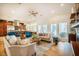 Open-concept living room with a kitchen, fireplace, natural light, and hardwood floors at 402 Westwood Dr, Chapel Hill, NC 27516