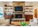 Comfortable living room with stone fireplace, built-in shelving, and hardwood floors at 402 Westwood Dr, Chapel Hill, NC 27516