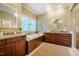 Beautiful, naturally lit main bathroom with double vanities and a soaking tub at 402 Westwood Dr, Chapel Hill, NC 27516