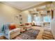 Comfortable bedroom with a seating area, rug, tray ceilings and natural light at 402 Westwood Dr, Chapel Hill, NC 27516
