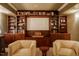 Entertainment room with a large screen, custom cabinetry, and comfortable seating at 402 Westwood Dr, Chapel Hill, NC 27516