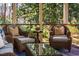 Screened porch with comfortable wicker furniture creates an inviting spot to unwind and enjoy the view at 402 Westwood Dr, Chapel Hill, NC 27516