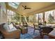 Inviting screened porch with wicker furniture and a ceiling fan, perfect for relaxing at 402 Westwood Dr, Chapel Hill, NC 27516