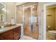 Spacious walk-in shower with glass door, built-in seat, and updated fixtures at 402 Westwood Dr, Chapel Hill, NC 27516