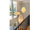 View of three modern hanging lights viewed from above a staircase landing at 402 Westwood Dr, Chapel Hill, NC 27516