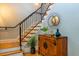 Stairway with white risers, wooden treads, black wrought iron railing and decorative table at 402 Westwood Dr, Chapel Hill, NC 27516